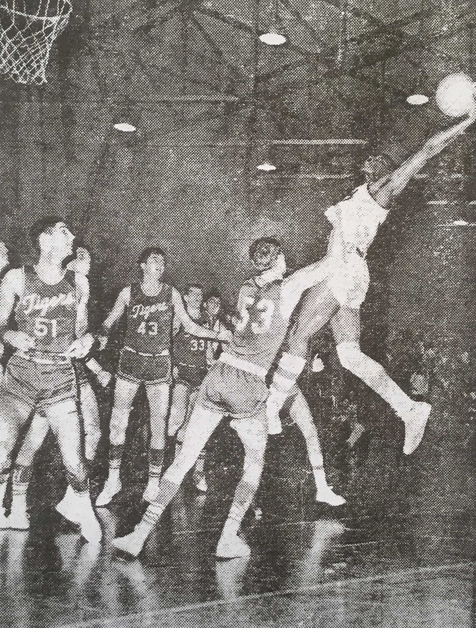 Black and white photo of a basketball game in Franklin Street Gym