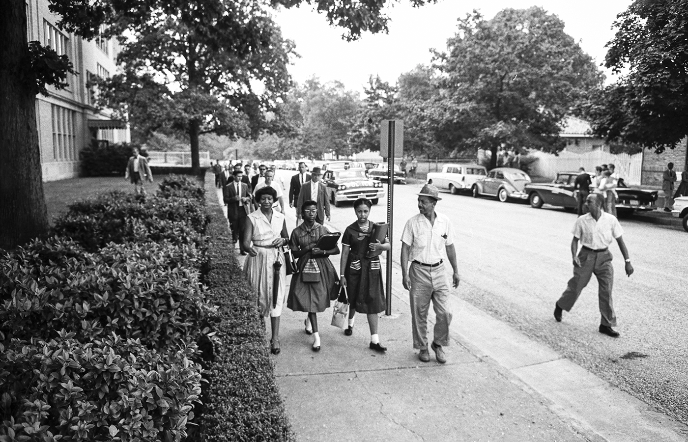 Gloria Mead and Carol Swann walking to school with their parents