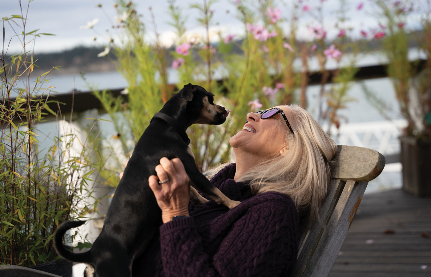 Luanne Freer with her dog, Poki, on the back deck of her home in Anacortes, Washington