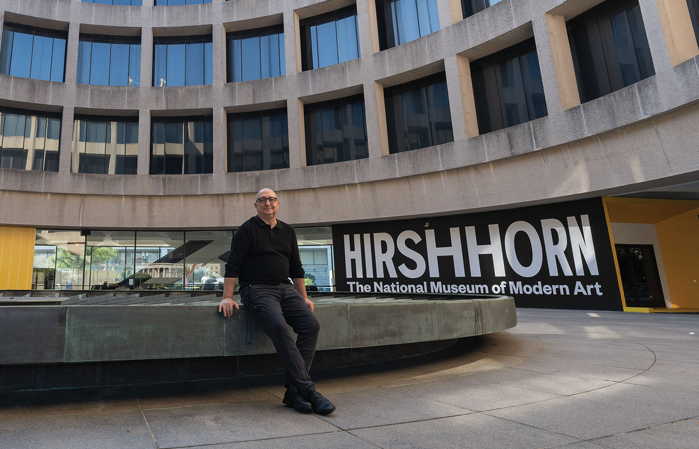 Scott Nolley leans against the fountain in the center of the Hirshhorn Museum