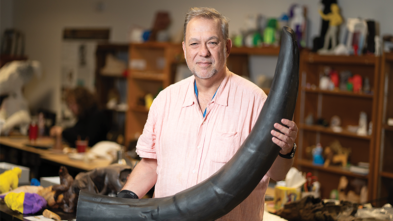 Bernard Means holding a mastodon tusk