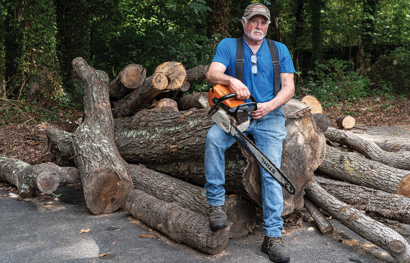 Buz holding a chain saw