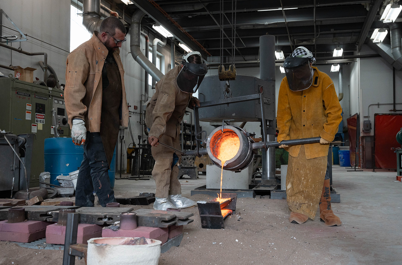 Once the sand molds are full, Tansey and Frank pour leftover bronze into ingots so that it can be reused in the next pour.