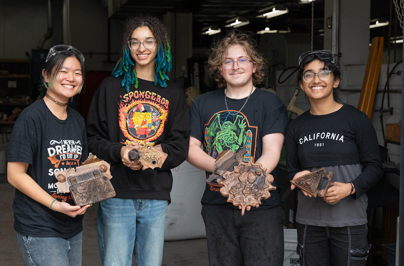 (Left to right) Liana Tai, Curly Carr, Hank Foreman and Henna Asthana present their bronze creations after cooling.