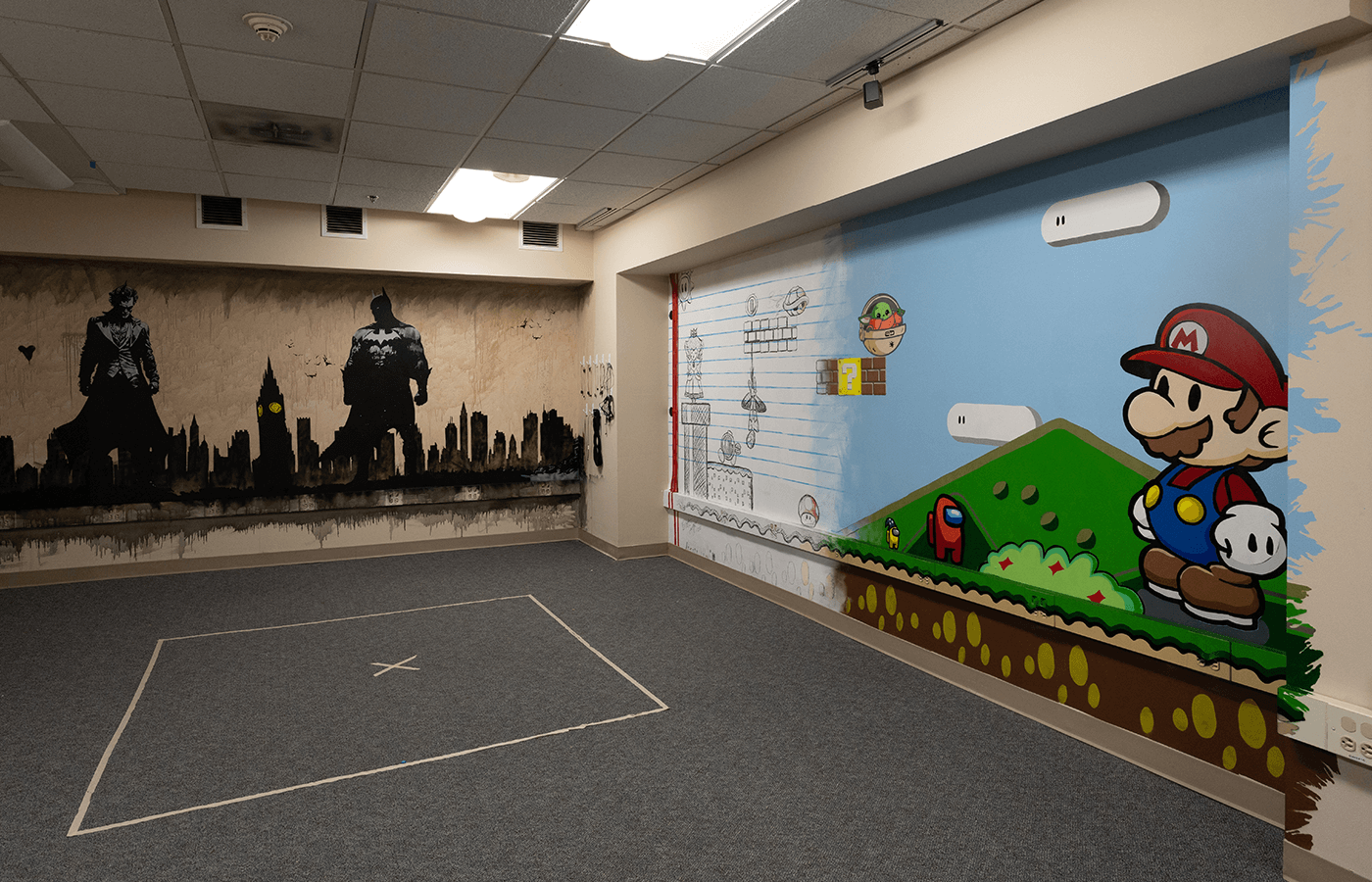 Two murals, one of Batman and one of Super Mario, in a medical center laboratory