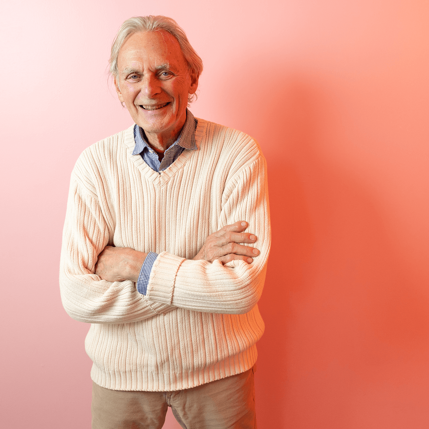 David Ashton standing in front of a pink wall