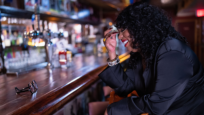 Cocoa Brown enjoys a lighter moment at the bar before a comedy show