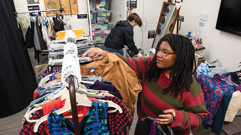 two students organize clothes at VCU's Suit Yourself Closet